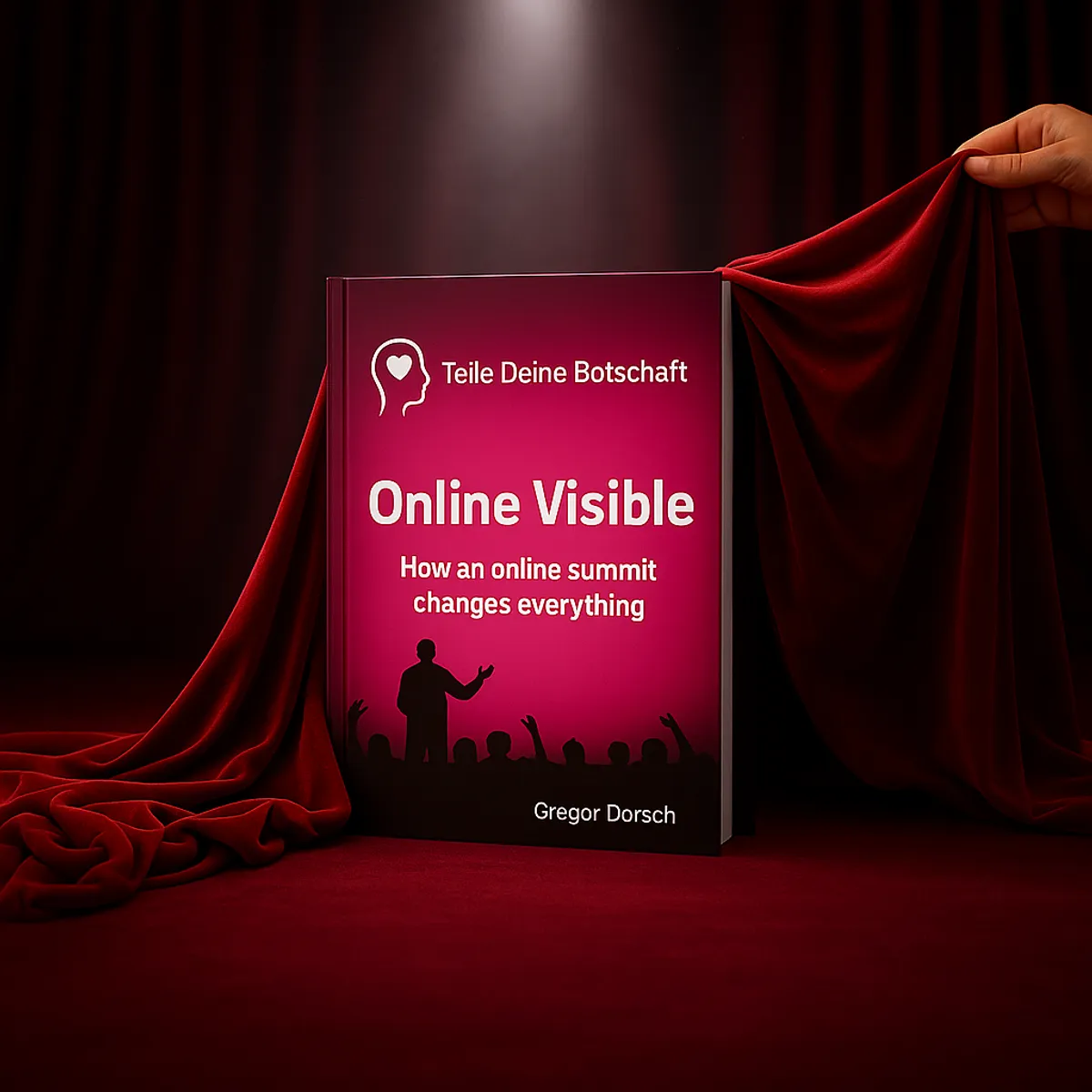 The book revealed under a red velvet cloth on a spotlit stage